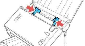 A plastic card being aligned carefully at the edge of a scanner input tray, ready for processing